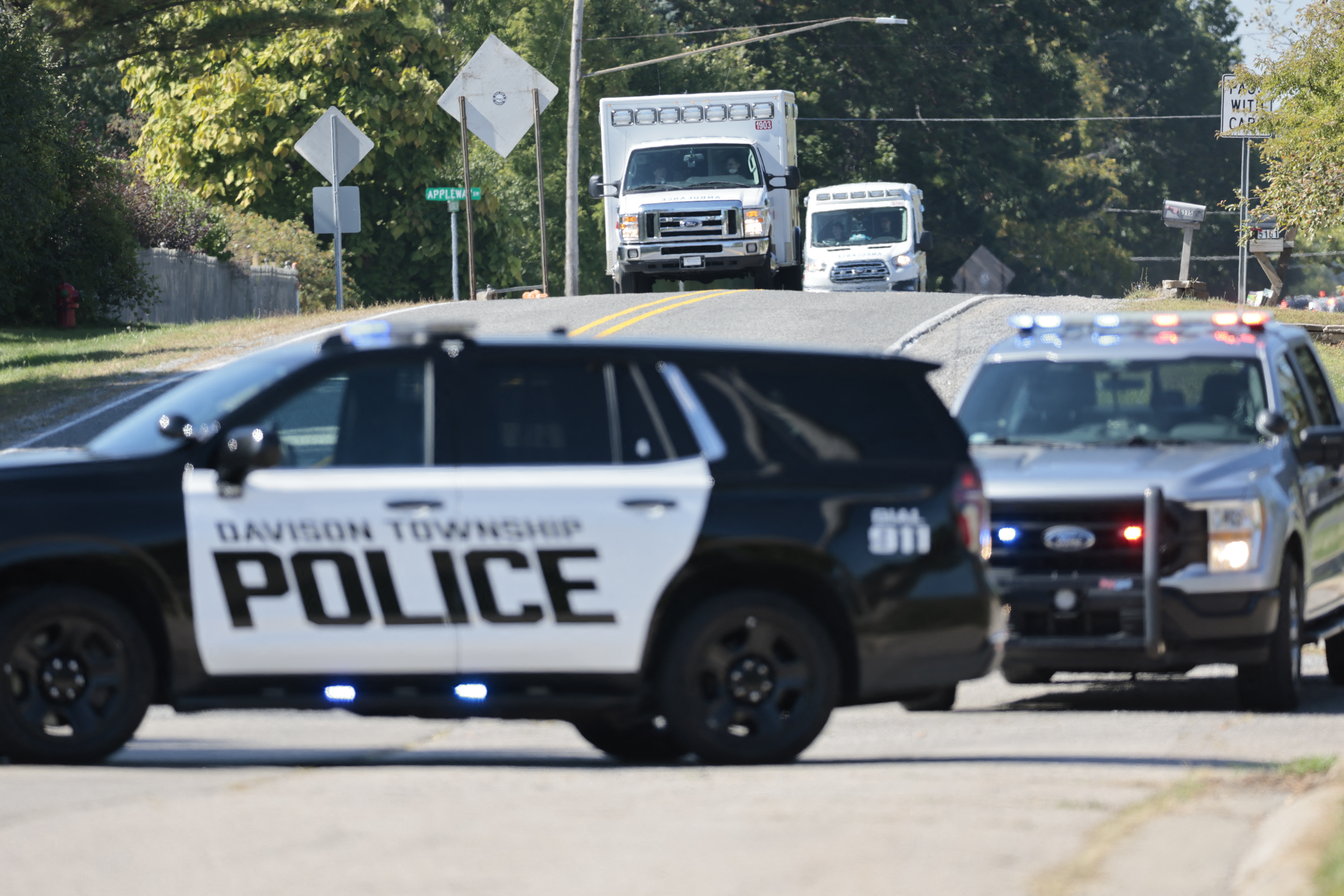 Police and emergency vehicles respond near the scene of a shooting at a church in Grand Blanc, Michigan, on September 28, 2025.