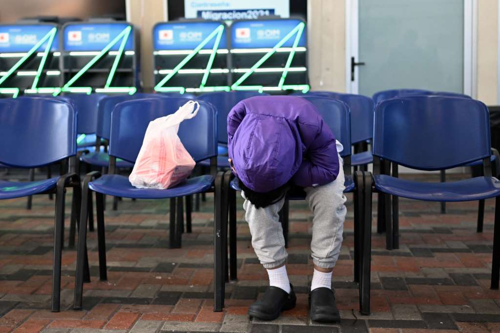 A Guatemalan migrant deported from the United States waits at the Returnee Reception Center upon arrival at the Guatemalan Air Force Base in Guatemala City on December 27, 2024, during the last deportee flight of the year.