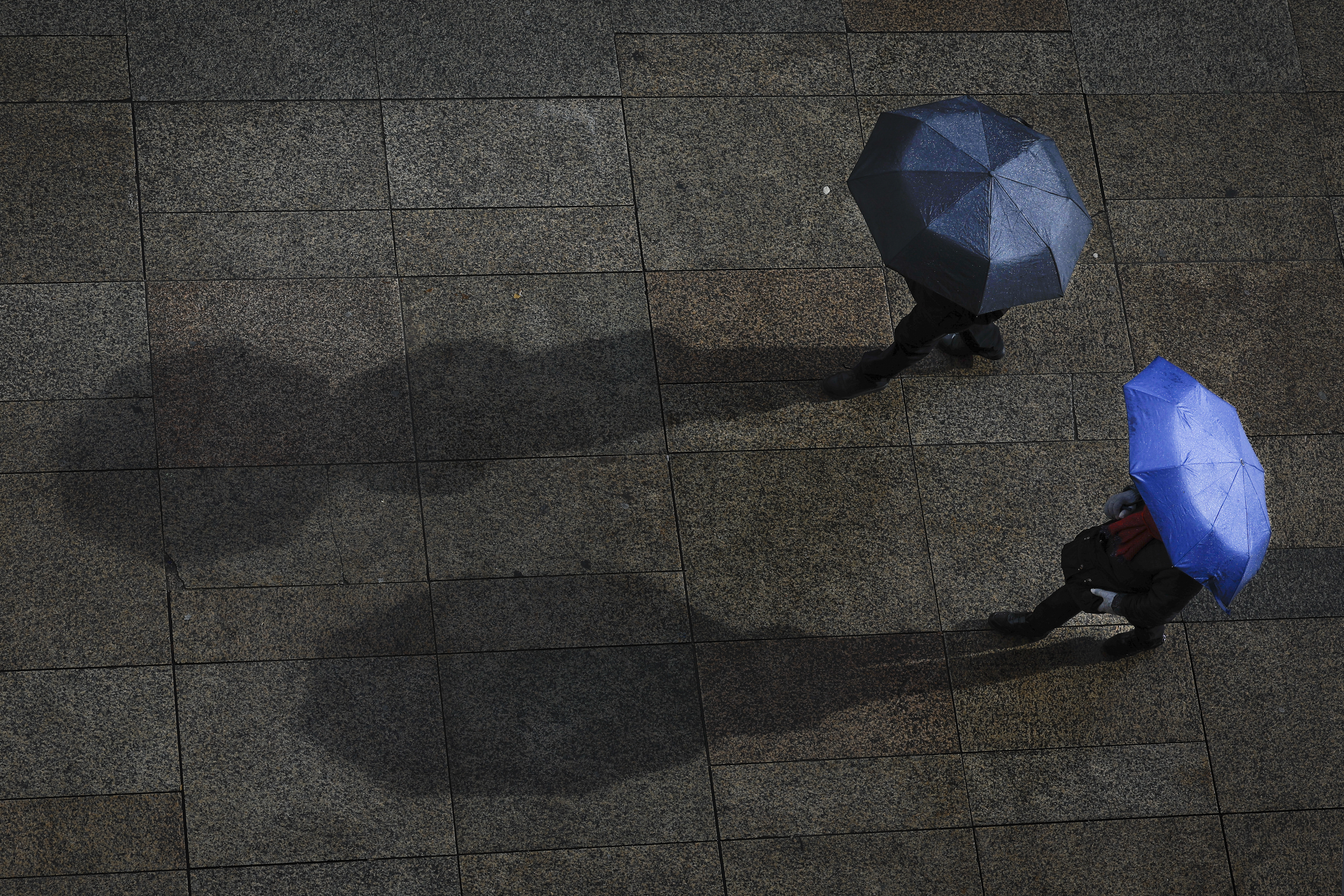-FOTODELDÍA- PAMPLONA (NAVARRA) 10/02/2024.- La influencia de la borrasca Karlotta pone el sábado prácticamente a toda España en aviso naranja o amarillo por rachas de viento fuertes, tormentas, fenómenos costeros y nevadas significativas en zonas montañosas del norte y centro peninsular. En la imagen, dos personas se protegen de la lluvia con sus paraguas en la Plaza del Castillo de Pamplona. EFE/Villar López