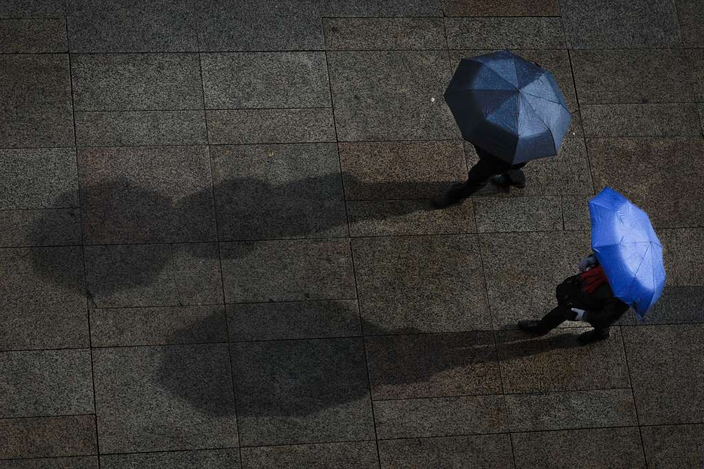-FOTODELDÍA- PAMPLONA (NAVARRA) 10/02/2024.- La influencia de la borrasca Karlotta pone el sábado prácticamente a toda España en aviso naranja o amarillo por rachas de viento fuertes, tormentas, fenómenos costeros y nevadas significativas en zonas montañosas del norte y centro peninsular. En la imagen, dos personas se protegen de la lluvia con sus paraguas en la Plaza del Castillo de Pamplona. EFE/Villar López