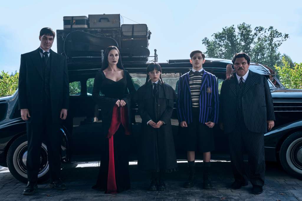 Wednesday. (L to R) Joonas Suotamo as Lurch, Catherine Zeta-Jones as Morticia Addams, Jenna Ortega as Wednesday, Isaac Ordonez as Pugsley Addams, Thing, Luis Guzmán as Gomez Addams in episode 201 of Wednesday. Cr. Helen Sloan/Netflix © 2025