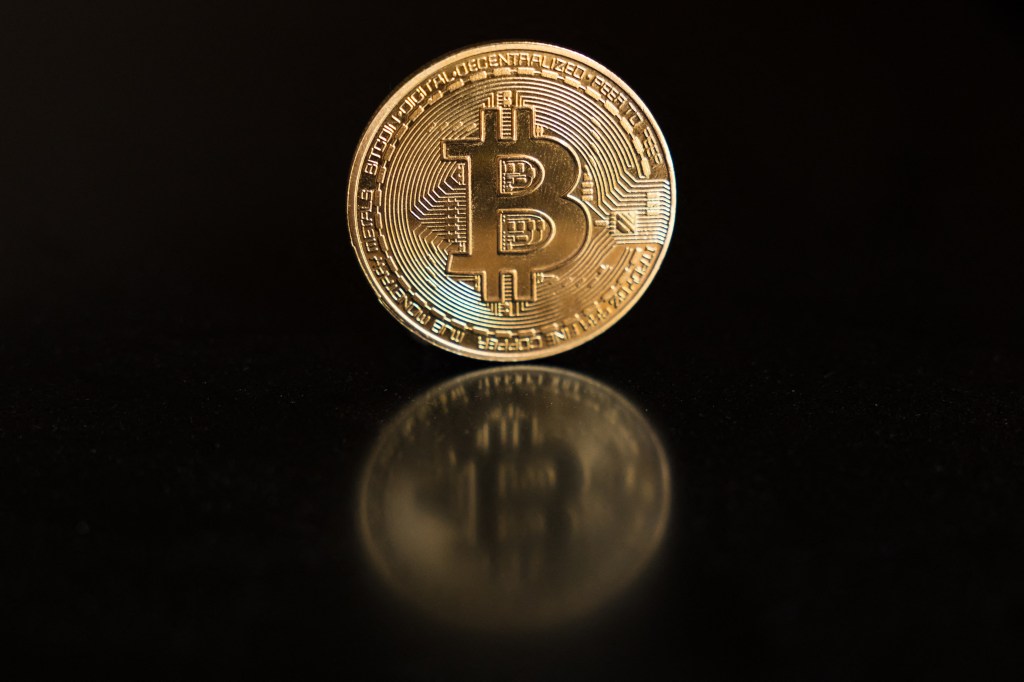 (FILES) This photo illustration shows a physical representation of a bitcoin in Hong Kong on April 16, 2024.