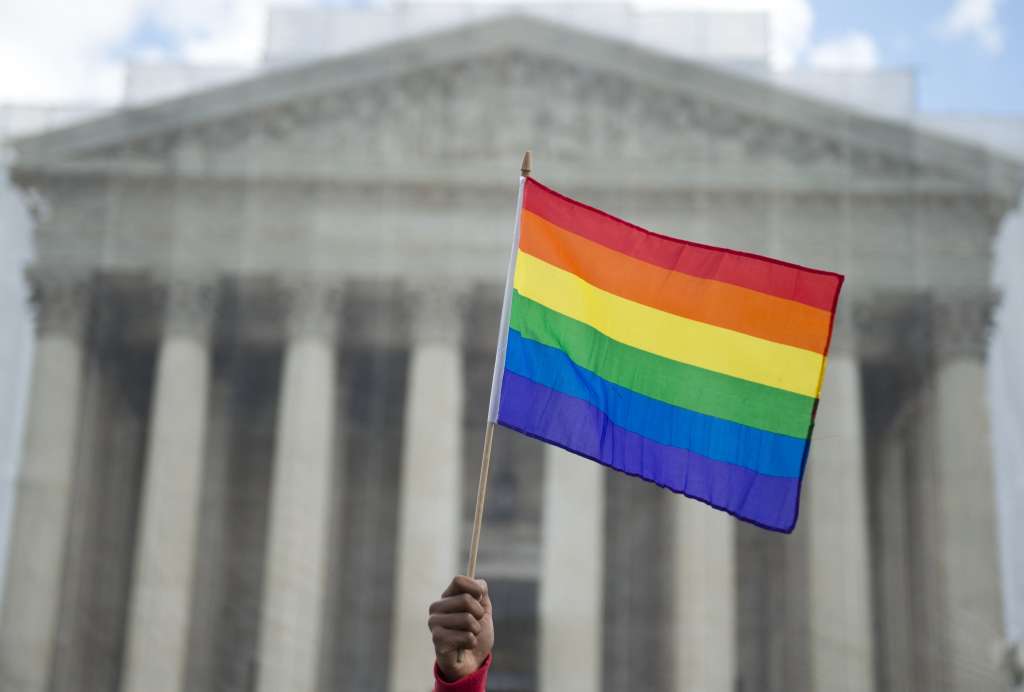 (FILES) A same-sex marriage supporter waves a rainbow flag in front of the US Supreme Court on March 26, 2013 in Washington, DC, as the Court takes up the issue of gay marriage.