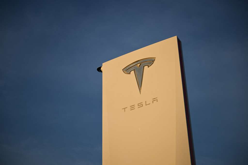 (FILES) The Tesla, Inc. logo is displayed on a sign outside the Tesla Design Center in Hawthorne, California, on August 9, 2022.
