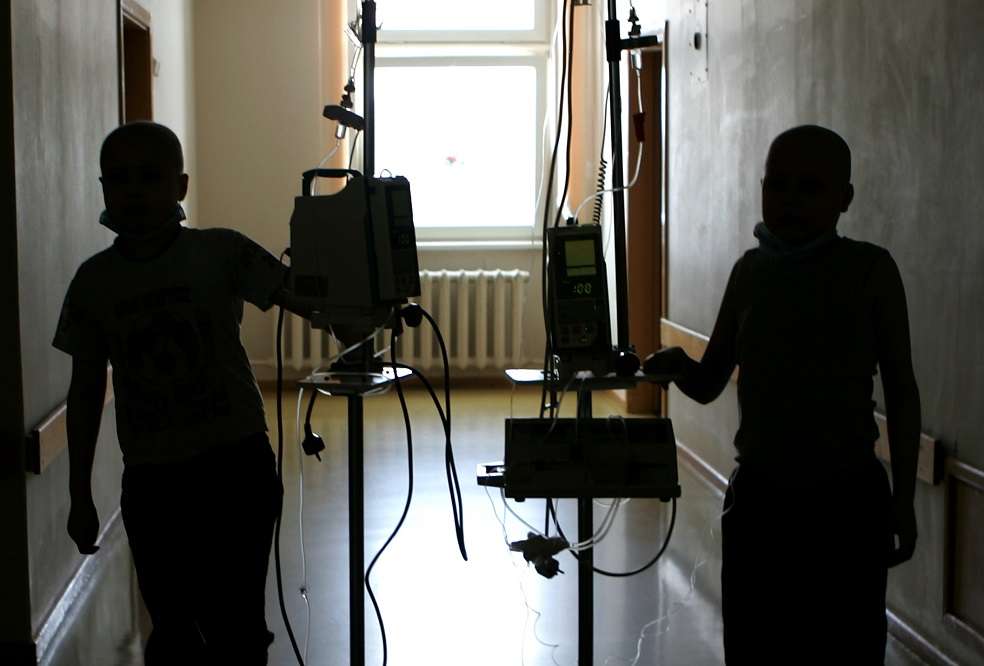 MINSK, BELARUS - MARCH 13: Pasha (left) from the city of Baranovichi and Vova (right) Kazakhstan walk down the hallway of the Children's Oncology Center on March 13, 2006 in Minsk, Belarus. Both children have been diagnoised with lymphoma. On April 26, 1986, reactor number four at the Chernobyl Nuclear Power Station on the border of the Ukraine and Belarus exploded. The fire, which burned out of control for five days, spewed more than 50 tons of radioactive fallout across Belarus. The wind carried the heaviest radioactive deposits across Belarus, where even today a large portion of the land is considered uninhabitable. The government denied the accident happened for several days, allowing the people in the Gomel region of Belarus to linger in the radiation. The cause of the medical illnesses are often hard to find, and much harder to prove. But, the rise in the number of cancer cases and other health problems in this region is too great for any other conclusion ? it has to be the radiation. (Photo by Ezra Shaw/Getty Images)