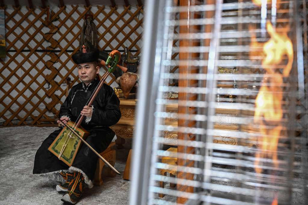 A man plays the Mongolia’s traditional instrument morin khuur, inside a Ger (Mongolian tent) during the “Mongols Nomadic Winter Festival” at National Park in Ulaanbaatar, the capital of Mongolia on February 20, 2025. (Photo by JADE GAO / AFP)