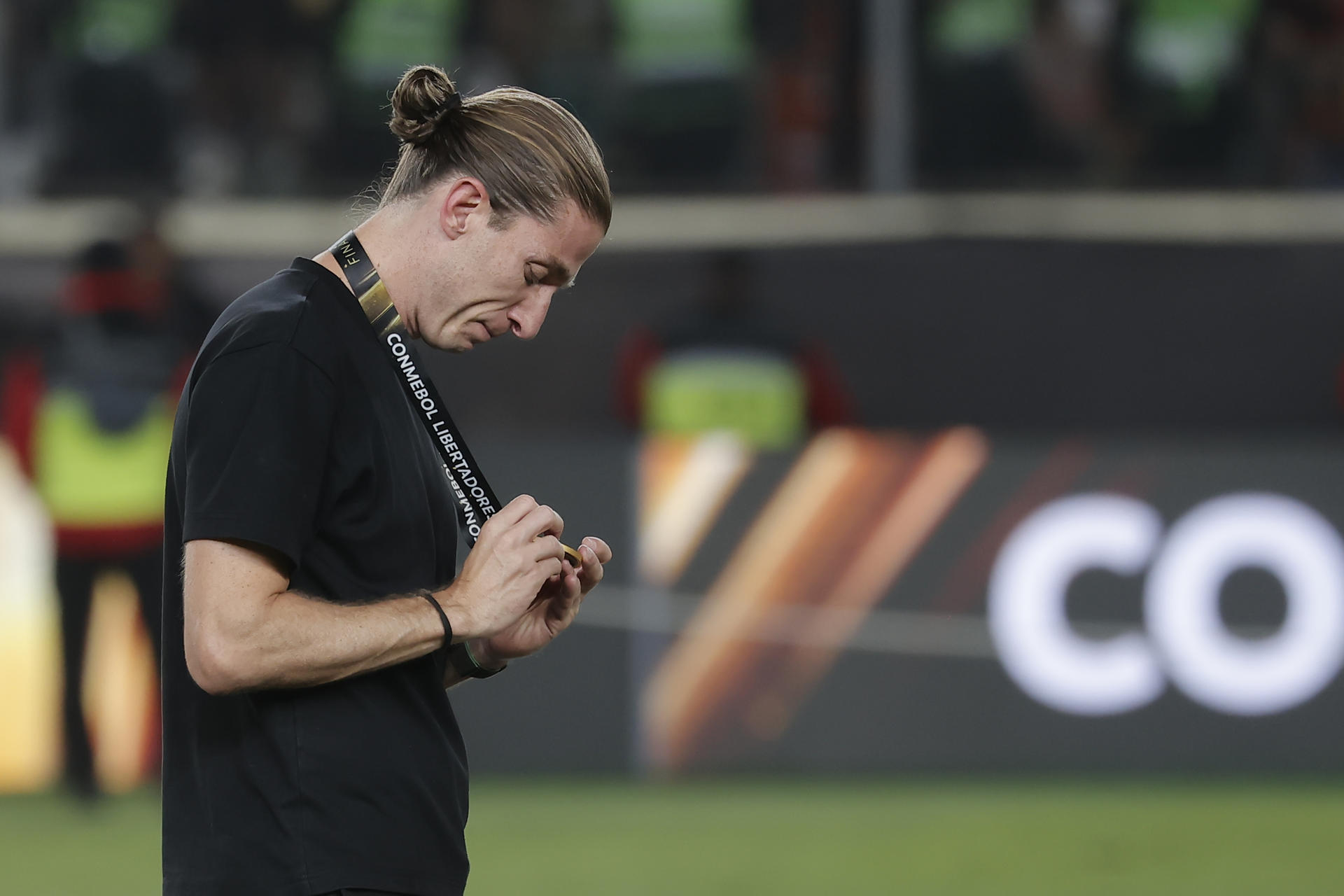 AMDEP9832. LIMA (PERÚ), 29/11/2025.- El entrenador de Flamengo Filipe Luís observa la medalla de campeón de la Copa Libertadores este sábado, en el estadio Monumental U, en Lima (Perú). EFE/ José Jácome