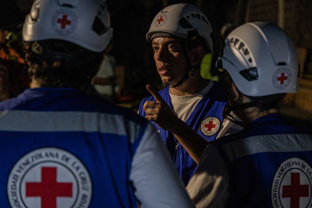 AME6037. CATIA LA MAR (VENEZUELA), 30/06/2026.- Rescatistas de la Cruz Roja Venezolana trabajan en la búsqueda de sobrevivientes por el doble terremoto de magnitud 7,2 y 7,5 que sacudieron la zona norte de Venezuela este lunes, en Catia La Mar, estado La Guaira (Venezuela). Los sismos han dejado al menos 1.719 muertos, principalmente por el colapso de numerosos edificios. EFE/ Henry Chirinos