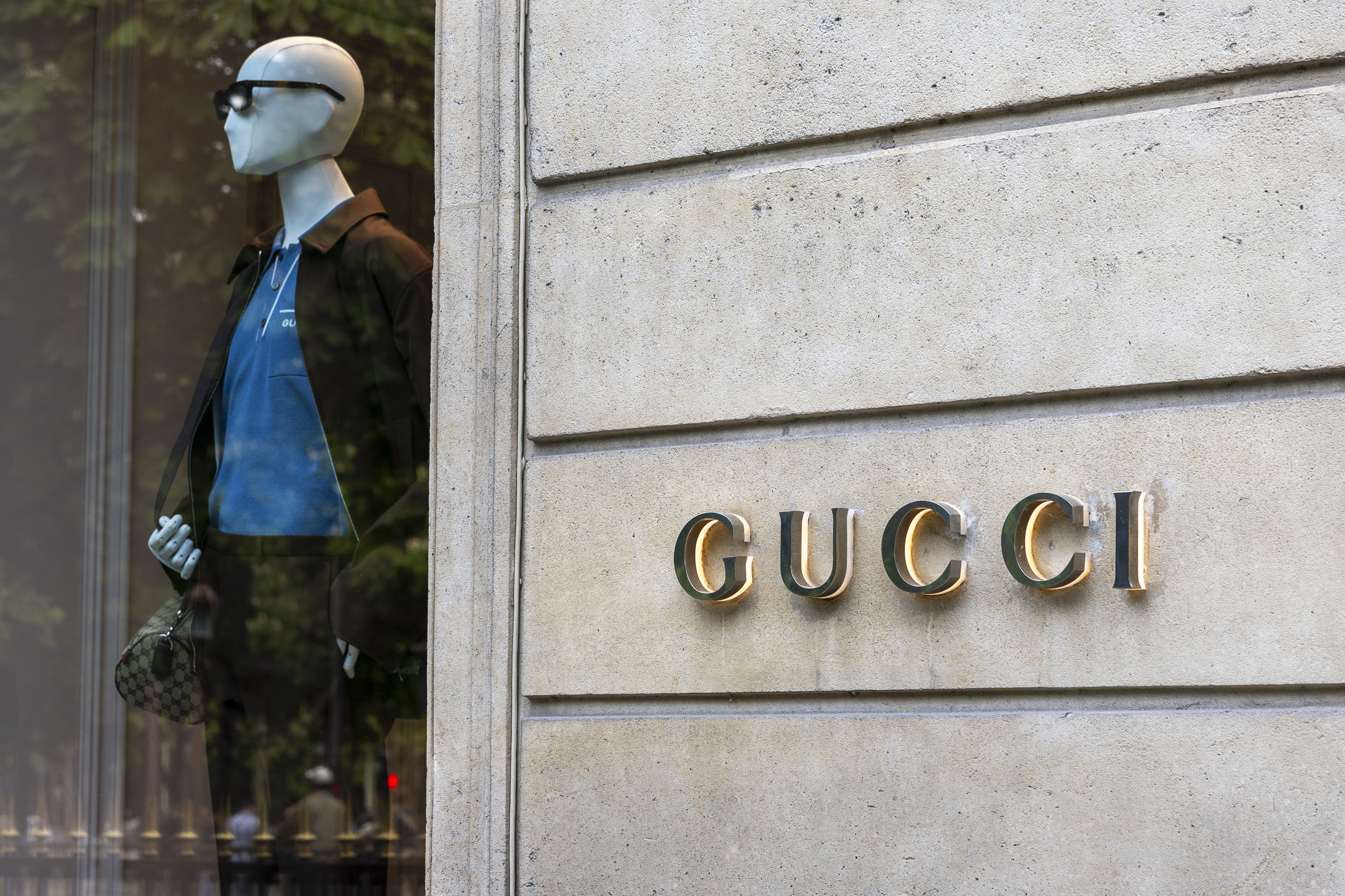 (FILES) This photograph shows a facade of a shop of Italian luxury fashion brand Gucci on Rue Montaigne in Paris on April 16, 2025.