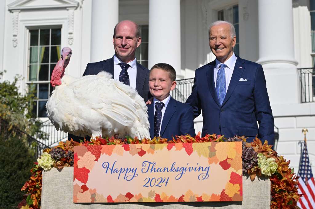 US President Joe Biden pardons Peach, the National Thanksgiving Turkey, alongside Chair of the National Turkey Federation John Zimmerman and his son Grant during an event on the South Lawn of the White House in Washington, DC, on November 25, 2024.