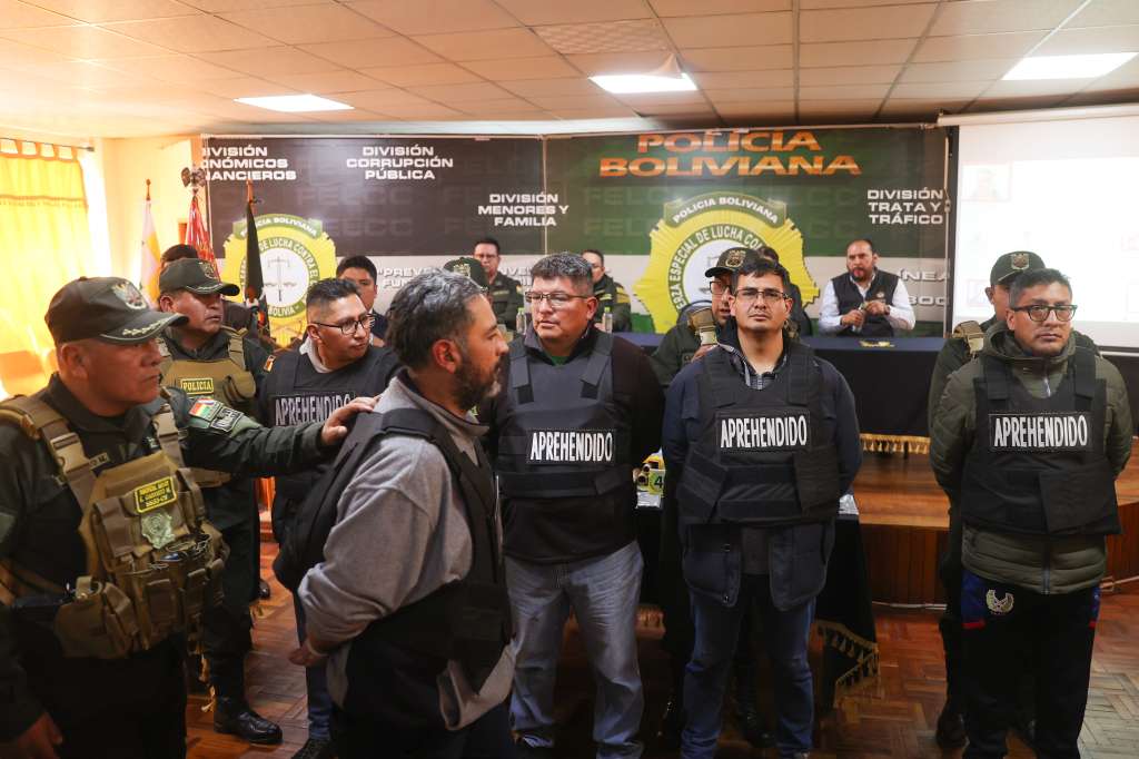 AME7245. LA PAZ (BOLIVIA), 27/06/2024.- Un integrante de la Policía de Bolivia escolta a militares detenidos luego del intento de golpe de estado en rueda de prensa este jueves, en La Paz (Bolivia). El ministro de Gobierno de Bolivia Eduardo Del Castillo presentó hoy en La Paz, en las dependencias de la Fuerza Especial de Lucha Contra el Crimen, a exmilitares en reserva y militares activos que fueron aprehendidos por su participación en el intento de golpe de Estado. EFE/ Luis Gandarillas