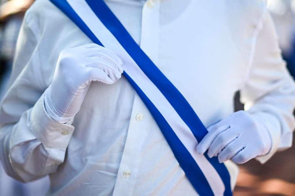 A students straightens a Salvadorean-flag sash during an event that kicks off civic festivities in El Salvador, at Las Brisas school, in San Salvador, El Salvador, on September 1, 2025.