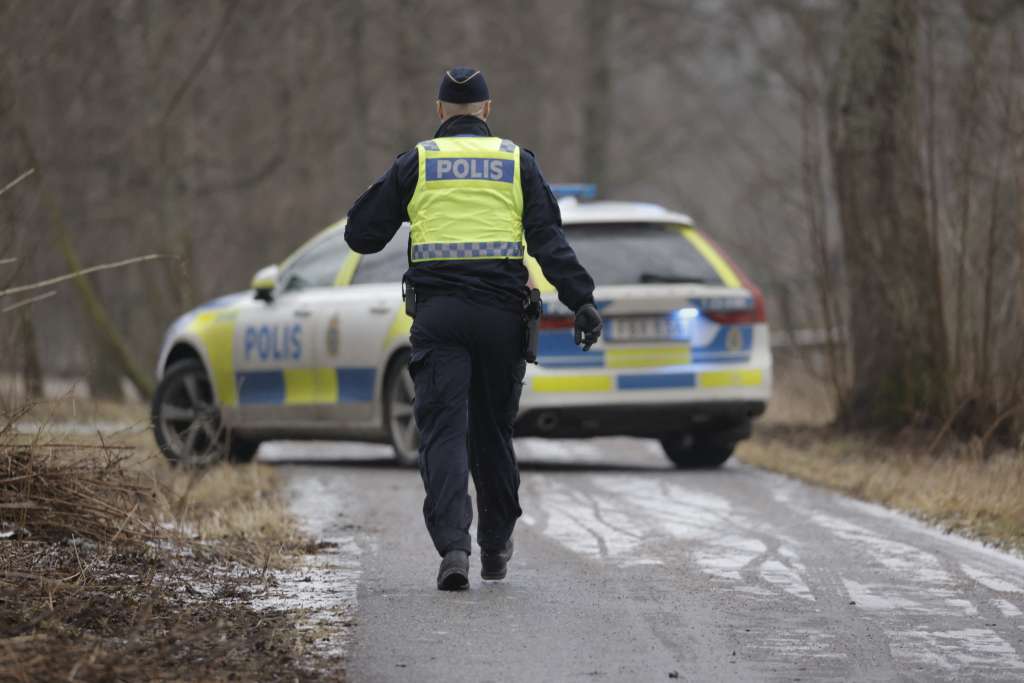 A police officers walks towards a police vehicle near the Risbergska School in Orebro, Sweden, on February 4, 2025, following reports of a serious violent crime.