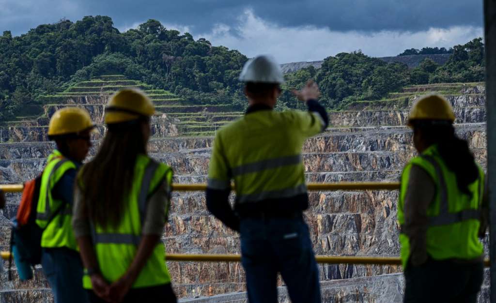 (FILES) Workers look at the Canadian First Quantum Panama copper mine in Donoso, Panama on March 21, 2025.