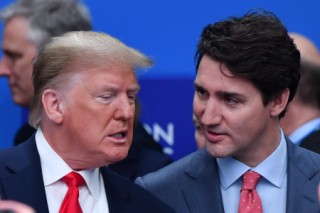 (FILES) US President Donald Trump (L) talks with Canada's Prime Minister Justin Trudeau during the plenary session of the NATO summit at the Grove hotel in Watford, northeast of London on December 4, 2019.