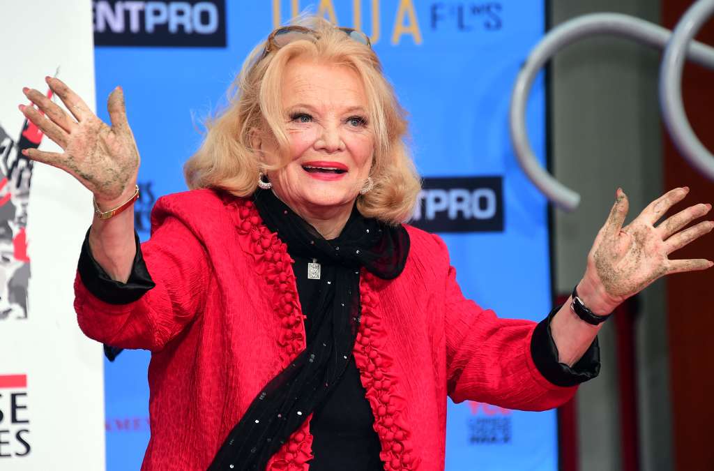 (FILES) Actress Gena Rowlands displays her hands after making her handprints at her Hand and Footprint ceremony in front of the TCL Chinese Theater IMAX in Hollywood, California on December 5, 2014.