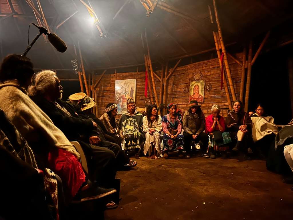Los mayores y las curanderas compartiendo la palabra en la casa sagrada.