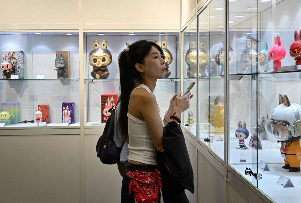 A woman visits the Yongle Auction office where limited-edition Labubu artworks are on display in Beijing on June 20, 2025 ahead of an auction on June 22. (Photo by Adek BERRY / AFP)