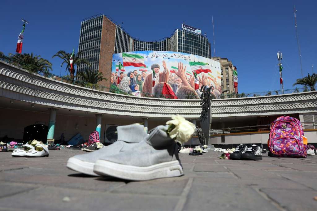 TEHRAN (IRAN(Islamic Republic Of)), 22/04/2026.- A huge poster of the late Iranian Supreme Leader Ayatollah Ali Khamenei is displayed alongside the symbolic belongings of Minab schoolgirls killed in a US airstrike, laid on the floor at Valiasr Square in Tehran, Iran, 22 April 2026. US President Donald Trump announced that the ceasefire between the US-Iran has been extended. (Teherán) EFE/EPA/ABEDIN TAHERKENAREH