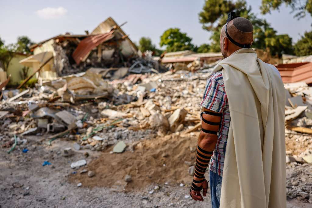 Sderot (Israel), 22/10/2023.- epaselect A man prays in front of destroyed houses in Kibbutz Be'eri, Israel, 22 October 2023. (Issued 07 November 2023). 07 November 2023, marks one month since Hamas militants launched an attack against Israel from the Gaza Strip, which was followed by Israeli operations in Gaza and the West Bank. More than 10,000 Palestinians and at least 1,400 Israelis have been killed and more than 200 others were taken hostage by Hamas militants, according to the Palestinian health authority and the Israel Defense Forces (IDF). (Kibutz) EFE/EPA/HANNIBAL HANSCHKE ATTENTION: This Image is part of a PHOTO SET