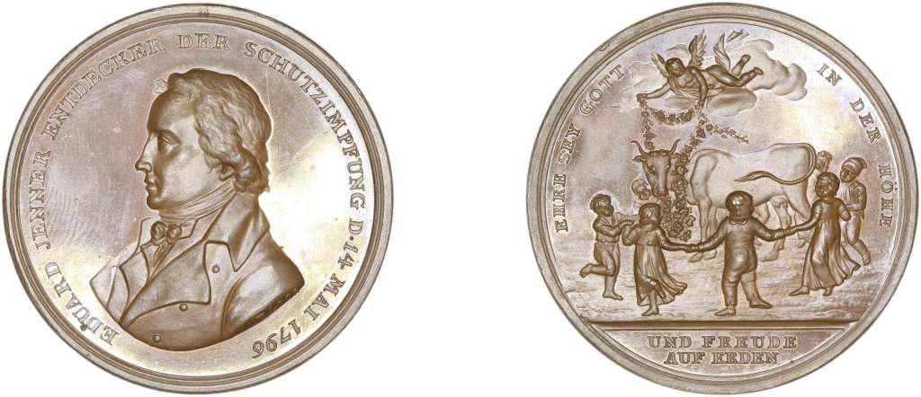 Medalla en bronce, acuñada en Alemania en 1838. (36 mm, 14.60 g). Emitida en reconocimiento de Edward Jenner, con una imagen de niños tomados de la mano bailando alrededor de una vaca, con un ángel en medio de las nubes arriba sosteniendo una guirnalda de rosas.