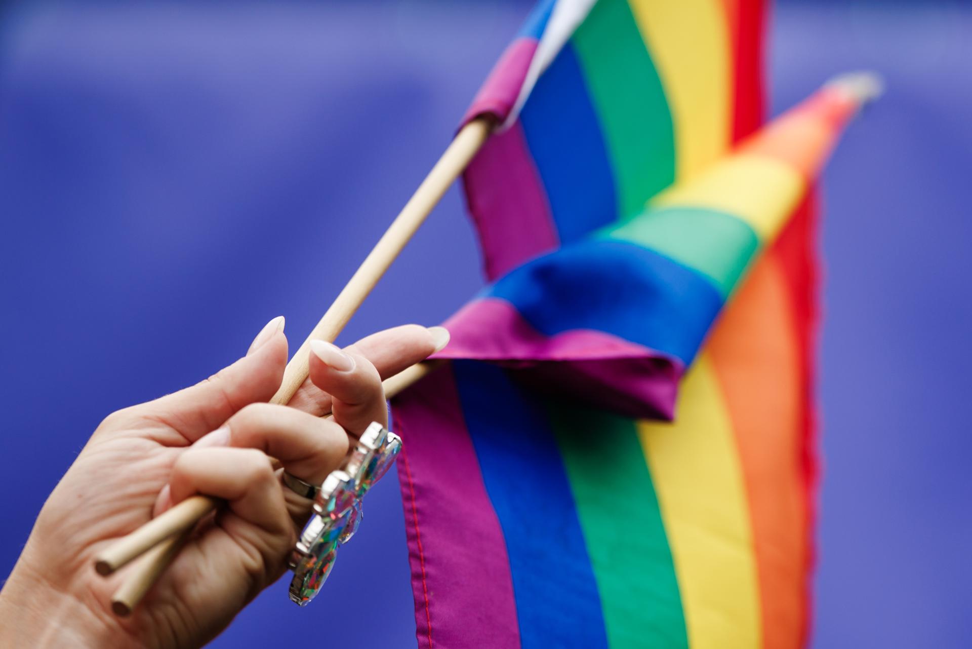 Berlin (Germany), 26/07/2025.- A participant holds rainbow flags during the 'CSD Berlin 2025,' the Christopher Street Day parade in Berlin, Germany, 26 July 2025. The 47th Christopher Street Day takes place under the motto 'Never be silent again!'. (Alemania) EFE/EPA/CLEMENS BILAN