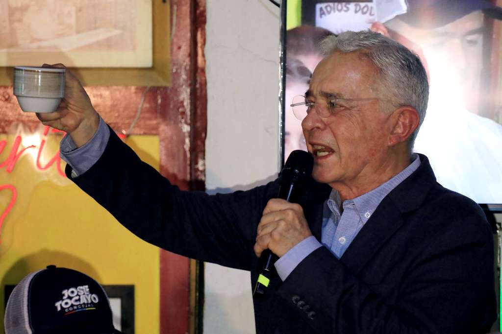 (FILES) Former Colombian President Alvaro Uribe Velez gestures as he speaks to the press after being released from house arrest in Sabaneta, Antioquia department, Colombia on August 20, 2025.