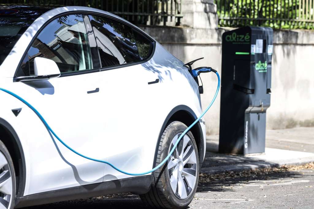 (FILES) A photo shows an electric car being recharged at a charging station in a street in Toulouse, southwestern France, on July 17, 2023.