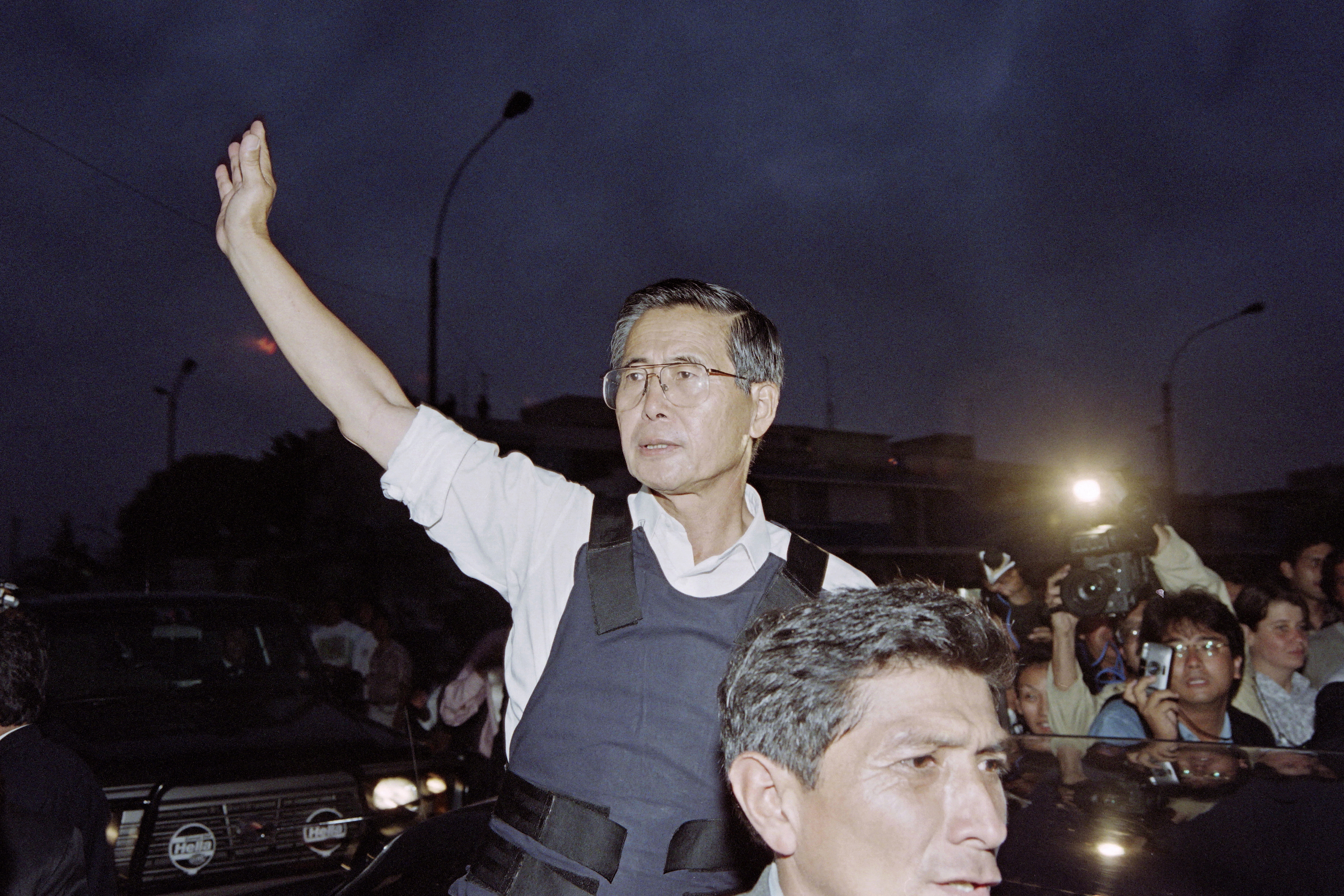 (FILES) A file picture taken on April 22, 1997 shows Peruvian President Alberto Fujimori waving as he leaves the residence of the Japanese ambassador in Lima.