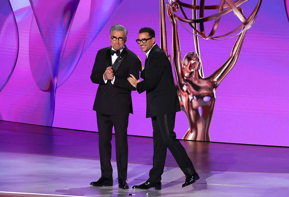 LOS ANGELES, CALIFORNIA - SEPTEMBER 15: (L-R) Hosts Eugene Levy and Dan Levy speak onstage during the 76th Primetime Emmy Awards at Peacock Theater on September 15, 2024 in Los Angeles, California. (Photo by Leon Bennett/WireImage)