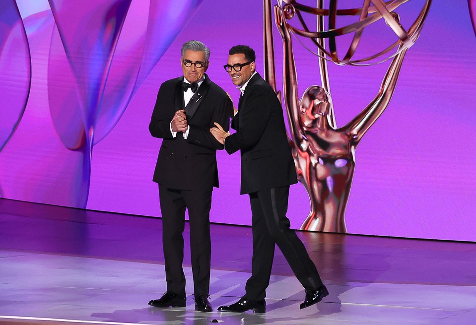 LOS ANGELES, CALIFORNIA - SEPTEMBER 15: (L-R) Hosts Eugene Levy and Dan Levy speak onstage during the 76th Primetime Emmy Awards at Peacock Theater on September 15, 2024 in Los Angeles, California. (Photo by Leon Bennett/WireImage)