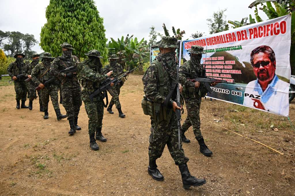 Members of the FARC dissident group Segunda Marquetalia marches on a farm in Llorente, a rural area of the port city of Tumaco, Nariño department, Colombia, on August 31, 2024.