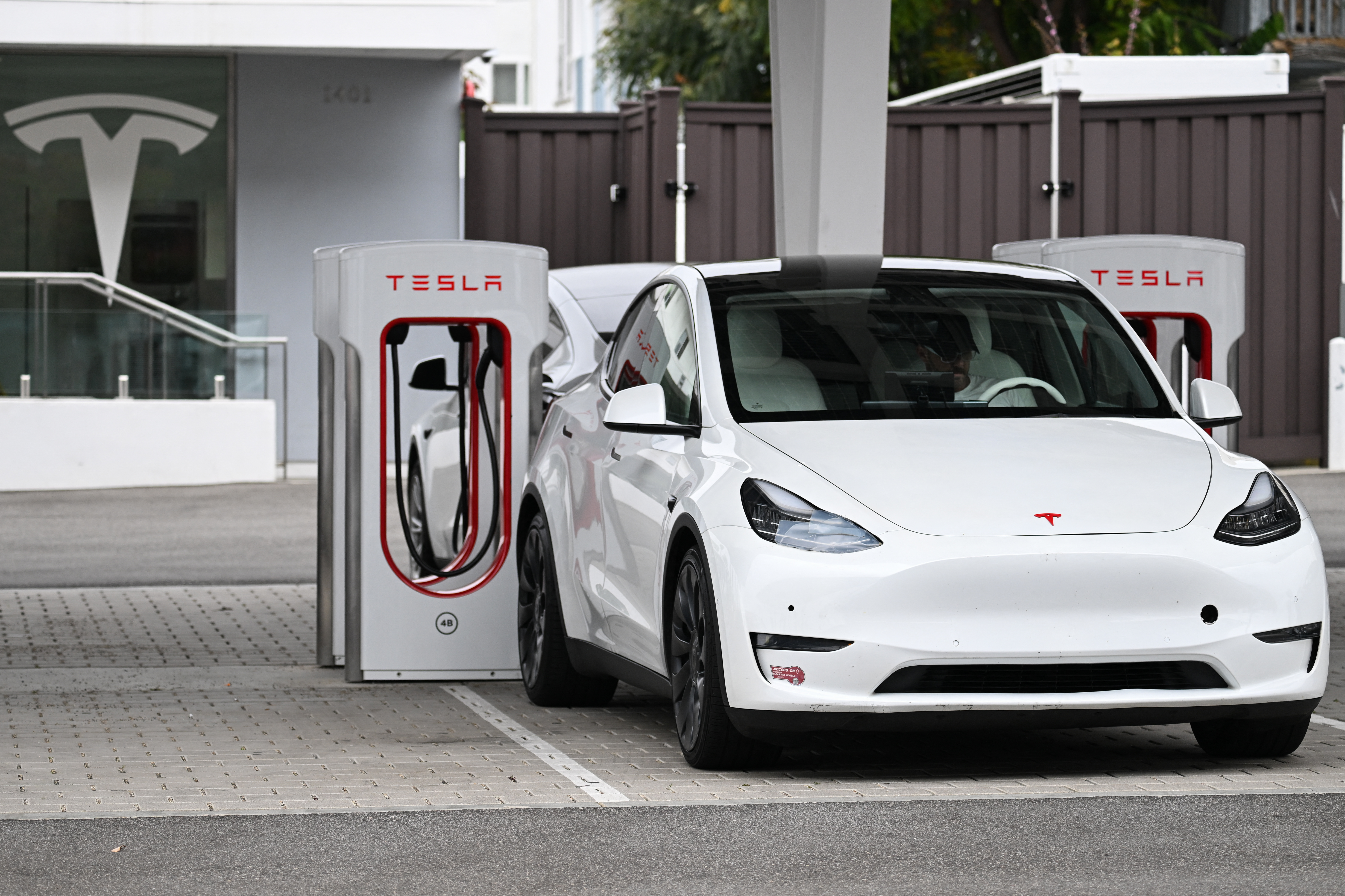 (FILES) A Tesla electric vehicle charges at a Tesla Supercharger location in Santa Monica, California on May 15, 2024.
