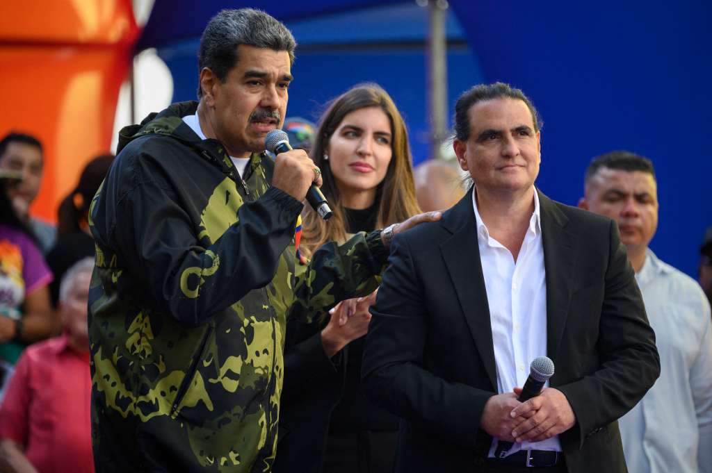 (FILES) Venezuela's President Nicolas Maduro (L) speaks to supporters next to Colombian-born businessman Alex Saab during a rally in support of his government in Caracas on January 23, 2024.