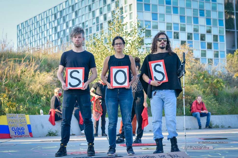 Daniel en compañía de sus amigos durante una protesta de colombianos frente a la Corte Penal Internacional (CPI).