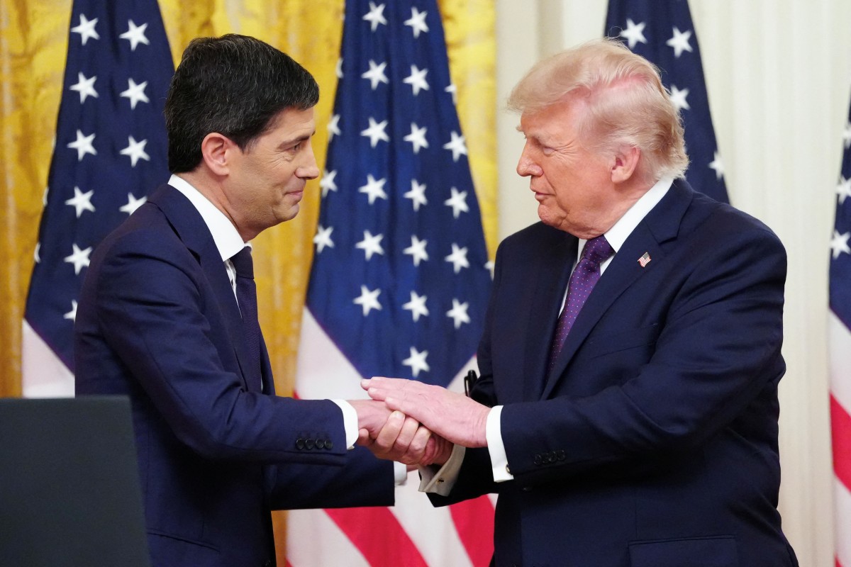(FILES) US President Donald Trump shakes hands with the new Chairman of the Federal Reserve Kevin Warsh (L) during a swearing in ceremony in the East Room of the White House in Washington, DC on May 22, 2026.