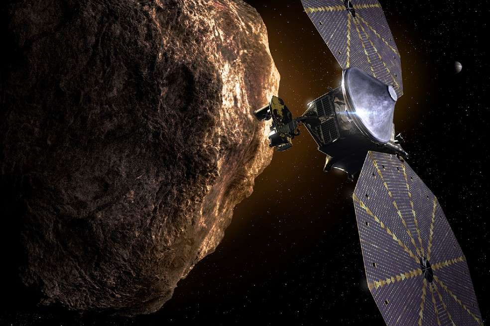 Esta ilustración muestra la nave espacial Lucy pasando por uno de los asteroides troyanos cerca de Júpiter.