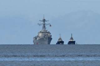 The USS Gravely warship is seen at a distance off the coast of Port of Spain on October 26, 2025.