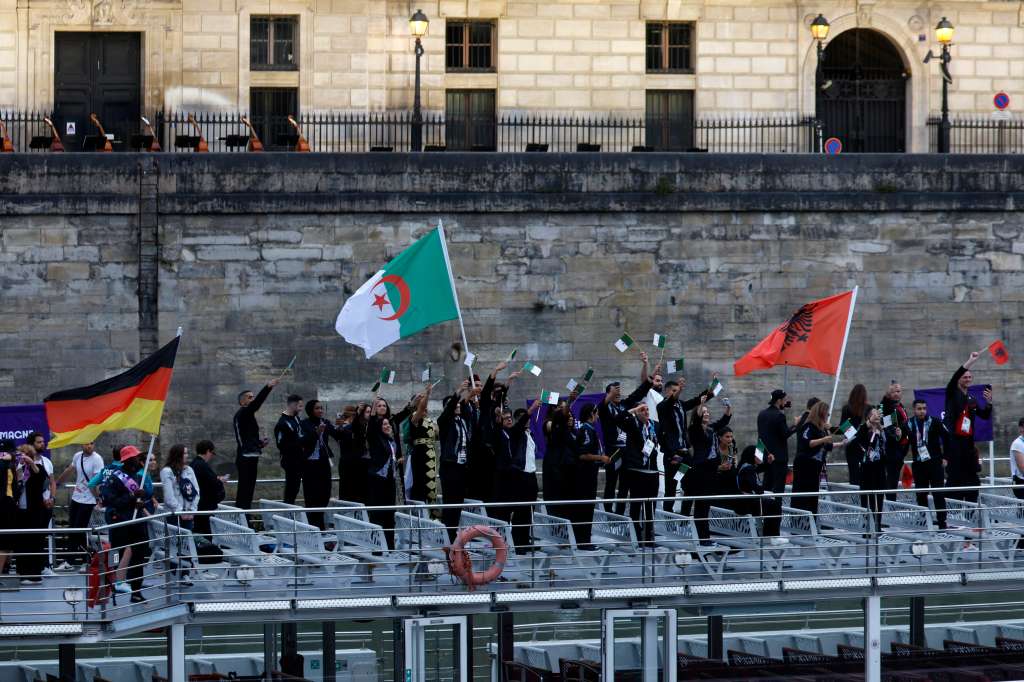 Paris (France), 26/07/2024.- Atheltes from Albania (R), Algeria (C), and Germany (L) wave their flags during the Opening Ceremony of the Paris 2024 Olympic Games, in Paris, France, 26 July 2024. (Francia, Alemania) EFE/EPA/MOHAMMED BADRA