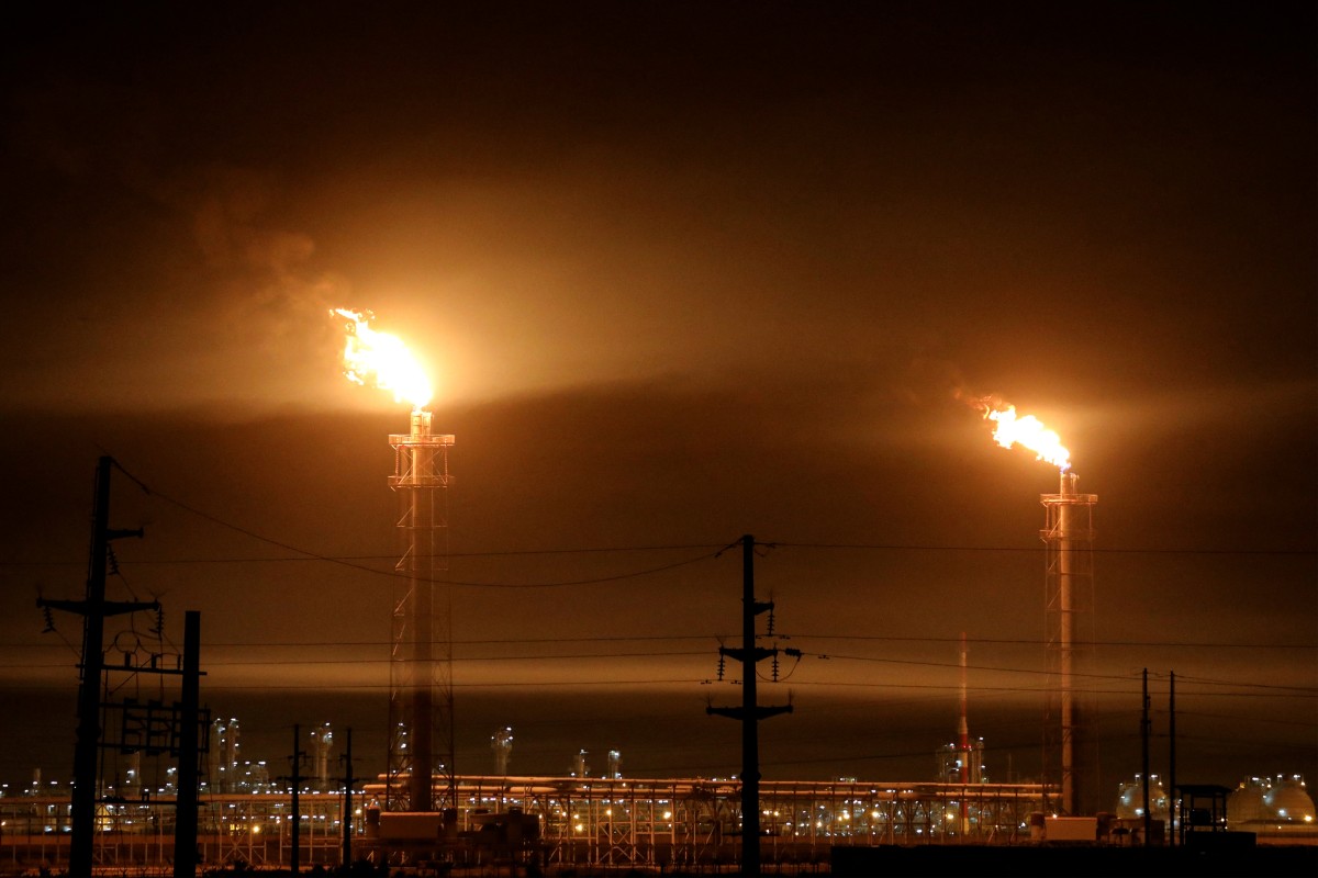 (FILES) Gas flares at an oil refinery near Iraq's receding marshes of Hawizeh, which straddle the border with Iran, in the southeastern Missan province on April 25, 2025.