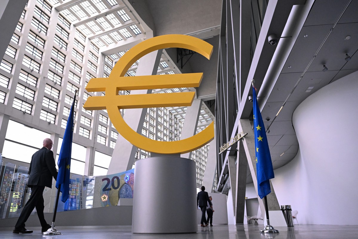 A visitor walks past a giant Euro sign inside the headquarters of the European Central Bank (ECB) in Frankfurt am Main, western Germany, on June 11, 2026, ahead of the bank's meeting on the Eurozone's monetary policy.