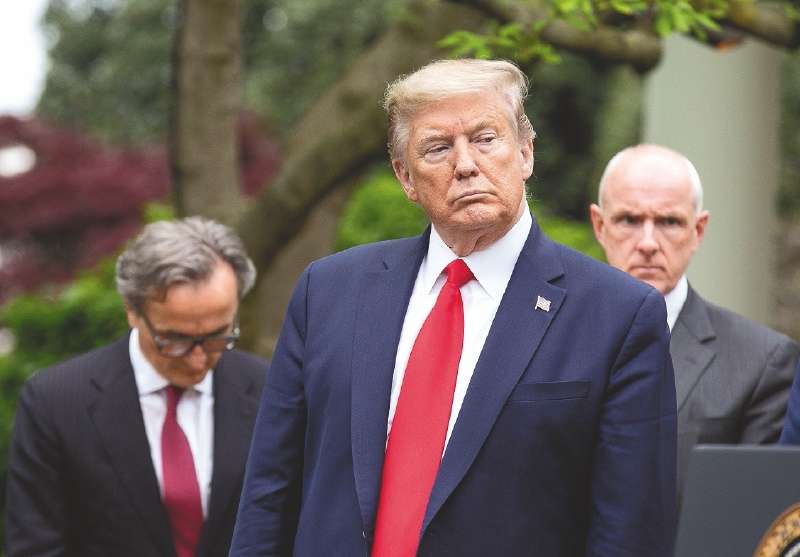 United States President Donald J. Trump listens during a news conference in the Rose Garden of the White House in Washington D.C., U.S. on Tuesday, April 14, 2020. Trump announced that he has instructed his administration to halt funding to WHO, the World Health Organization. Credit: Stefani Reynolds / CNP