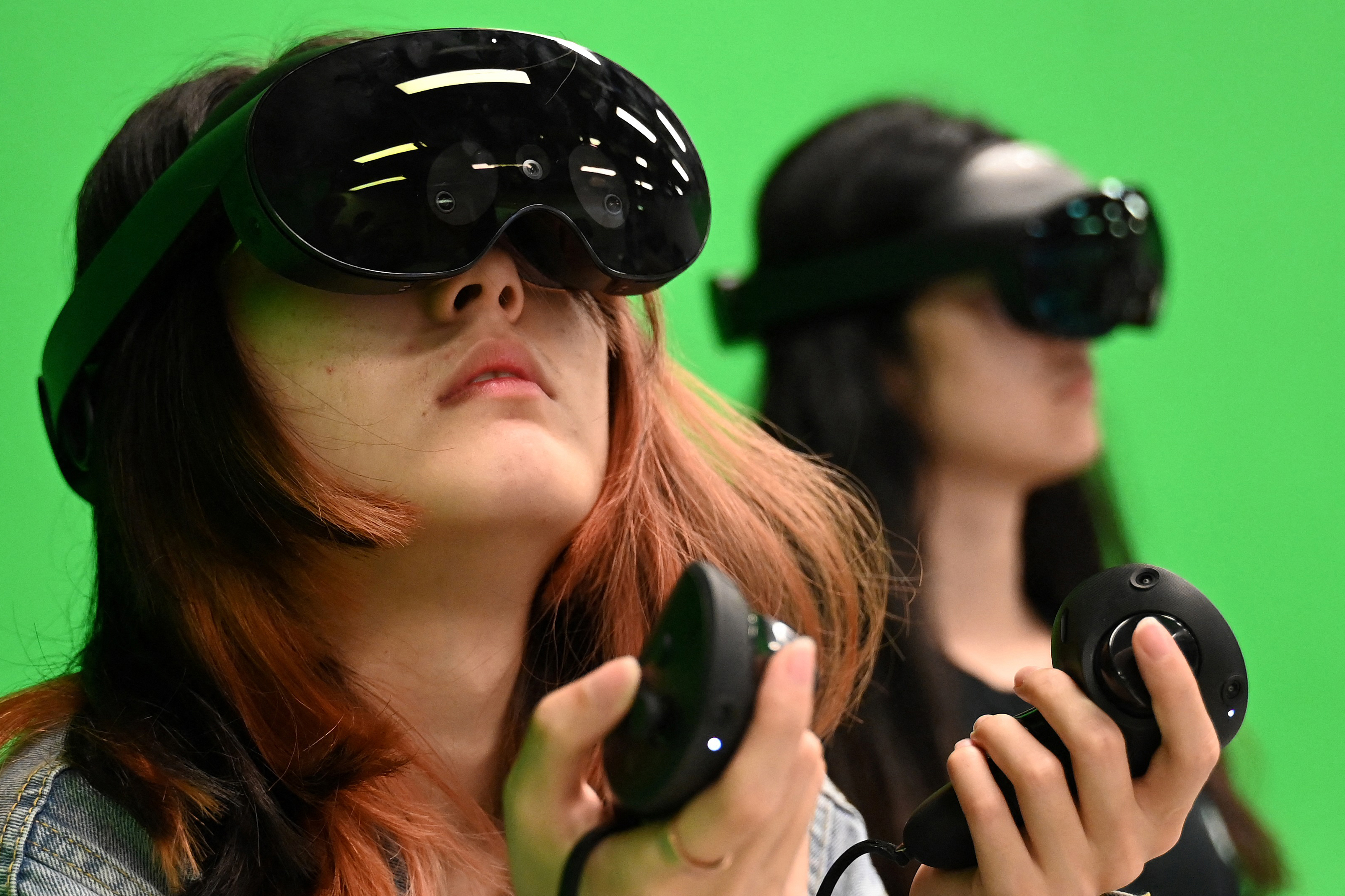 TOPSHOT - This photo taken on April 9, 2024 shows students using virtual reality headsets in a class at the Hong Kong University of Science and Technology (HKUST), in Hong Kong.