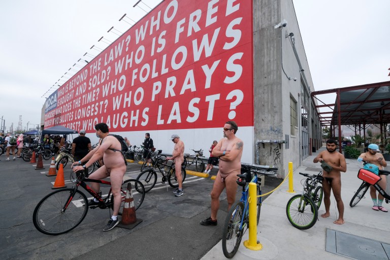EDITORS NOTE: Graphic content / Nude cyclists get ready for the World Naked Bike Ride on September 18, 2021 in downtown Los Angeles. (Photo by RINGO CHIU / AFP)