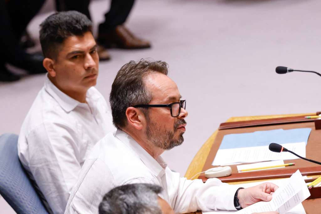 Carlos Ruiz Massieu, Special Representative for Colombia and Head of the United Nations Verification Mission in Colombia, speaks next to former Colombian guerrilla rebel Diego Ferney Tovar during the UN Security Council session on the progress of the Colombian peace process at UN headquarters in New York on July 11, 2024. (Photo by KENA BETANCUR / AFP)