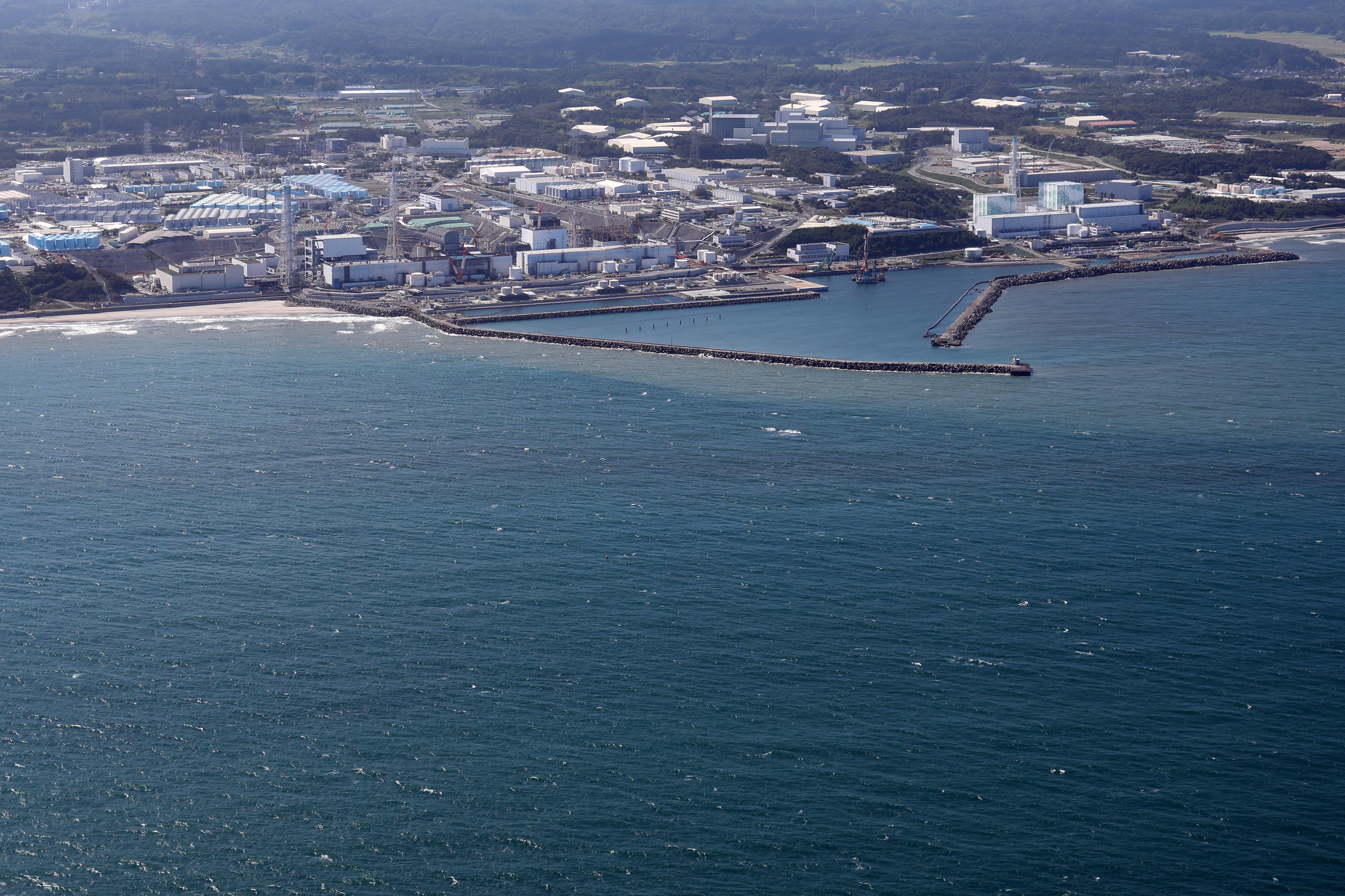 Okuma (Japan), 23/08/2023.- An aerial picture of the Fukushima Daiichi nuclear power plant and its tanks containing radioactive water in Okuma, Fukushima Prefecture, Japan, 24 August 2023. On 24 August in the early afternoon, plant operator Tokyo Electric Power Company Holdings Inc. (TEPCO) started the discharge of treated radioactive water from the Fukushima nuclear power plant into the Pacific Ocean despite opposition of local fishermen and some neighboring countries. It shall take as long as 30 years to complete the release of the treated radioactive water from more than 1,000 tanks. (Japón, Tokio) EFE/EPA/JIJI PRESS JAPAN OUT EDITORIAL USE ONLY/