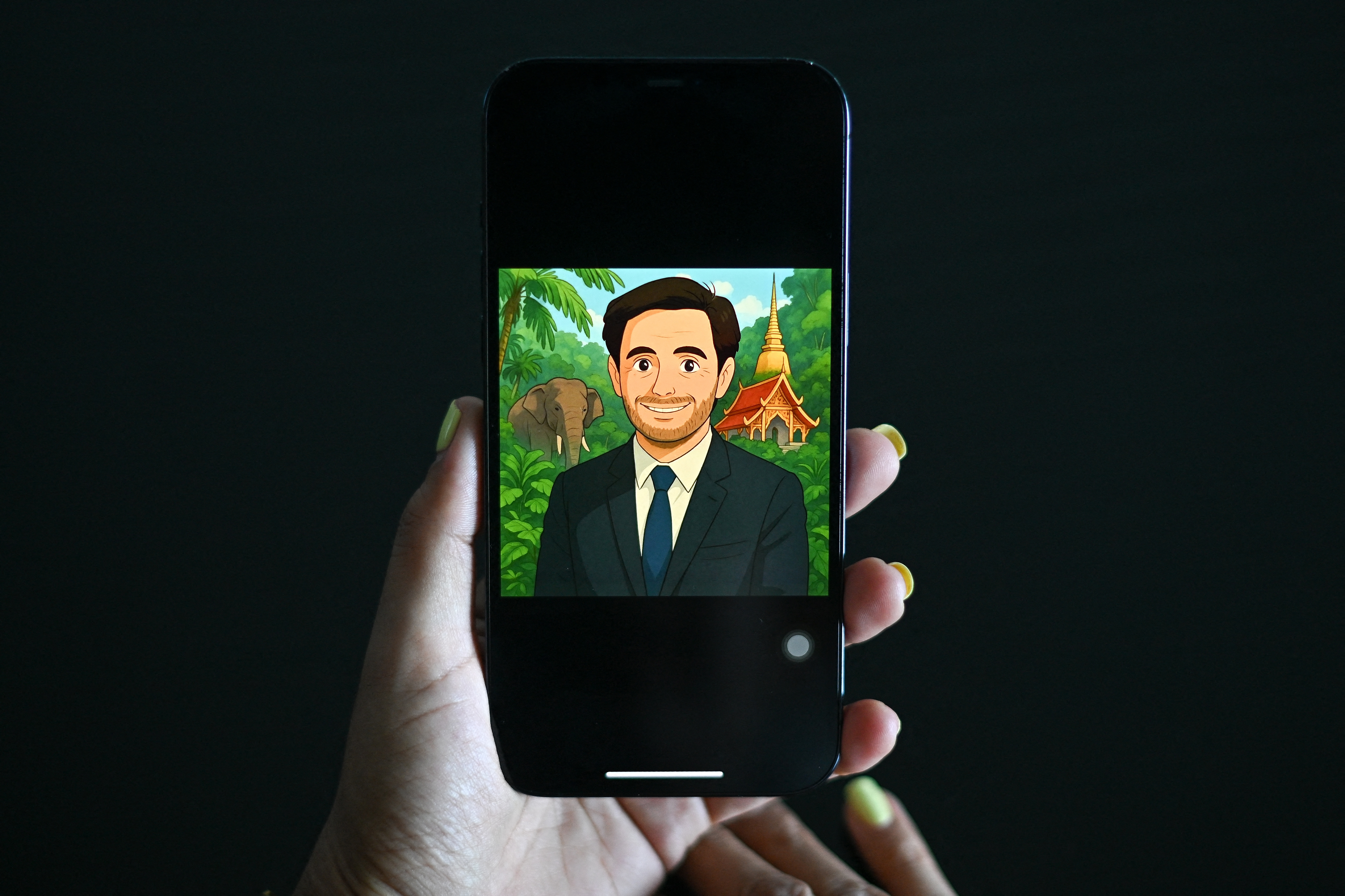 This photo illustration taken on April 2, 2025 shows a woman looking at a Facebook user profile displaying an image generated by artificial-intelligence (AI) in the style of Studio Ghibli animation on a mobile phone in Bangkok.
