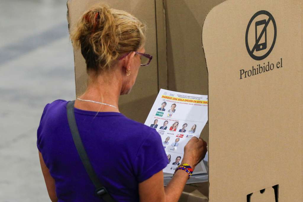 AME2076. MEDELLÍN (COLOMBIA), 08/03/2026.- Una persona observa un tarjetón electoral este domingo, en Medellín (Colombia). Las elecciones legislativas y las consultas interpartidistas a la Presidencia de Colombia superaron su ecuador sin hechos graves que afecten las votaciones y con una alta participación ciudadana, confirmaron las autoridades. EFE/ STR