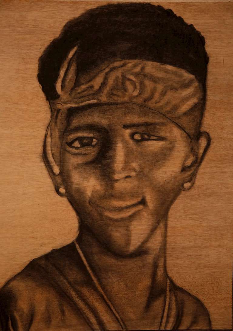 Reproducción fotográfica de un retrato hecho con ceniza de Jean Paul Perlaza, uno de los cinco jóvenes asesinados en Llano Verde.