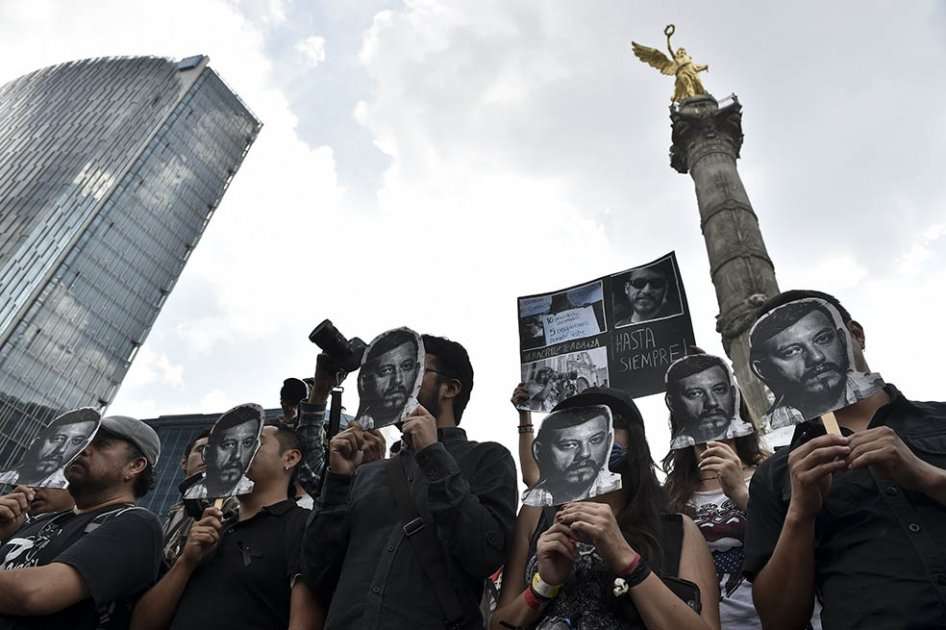 Manifestantes con el rostro impreso de Rubén Espinosa en Ciudad de México. / AFP